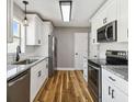 Bright kitchen features white cabinets, stainless steel appliances, and granite countertops at 1353 Lajolla Cir, The Villages, FL 32159