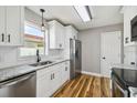 Bright kitchen features white cabinets, stainless steel appliances, and granite countertops at 1353 Lajolla Cir, The Villages, FL 32159