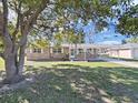 Inviting brick home with a covered carport and manicured front yard at 917 E Valencia St, Lakeland, FL 33805