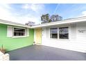 Inviting front entrance featuring a freshly painted door, updated windows, and stylish exterior details at 1730 John Arthur Way, Lakeland, FL 33803