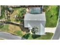 Aerial view of a home with a screened pool, landscaped backyard, and large lawn at 6677 Englelake Dr, Lakeland, FL 33813