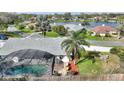 Aerial view of a home with screened pool, backyard, and lake view at 6677 Englelake Dr, Lakeland, FL 33813