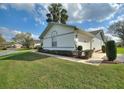 Side view of a well-kept home with lush lawn and neatly trimmed hedges at 6677 Englelake Dr, Lakeland, FL 33813