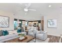 Bright and airy living room open to the kitchen, complete with stylish furniture and modern decor at 479 Pine Tree Blvd, Lake Alfred, FL 33850