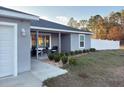 Street view of the home showing the front porch, garage, and landscaped yard at 15068 Sw 43Rd Ct, Ocala, FL 34473