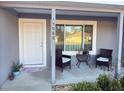 Close-up of the front porch with outdoor seating and decorative plants near the entrance at 15068 Sw 43Rd Ct, Ocala, FL 34473