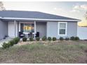 Inviting front porch featuring modern chairs and a small table, perfect for relaxing at 15068 Sw 43Rd Ct, Ocala, FL 34473