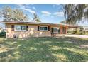 A cozy one-story house featuring a well-maintained lawn and classic design elements at 800 22Nd Nw St, Winter Haven, FL 33881