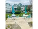 Community patio area with tables, chairs, and grills at 101 Bent Tree Dr # 12, Daytona Beach, FL 32114
