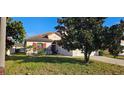 Charming single Gathering home featuring a beautifully landscaped front yard with a lovely Magnolia tree at 315 Villa Sorrento Cir, Haines City, FL 33844