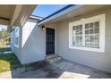 Exterior entrance showing the front door and adjacent window at 725 Strain Blvd, Lakeland, FL 33815