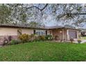 Lovely one-story home with manicured landscaping, brick accents, and a well-maintained front yard and driveway at 1176 Balfour Dr, Deltona, FL 32725