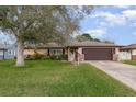 Attractive home with a lush green lawn and decorative landscaping enhancing its curb appeal at 1176 Balfour Dr, Deltona, FL 32725