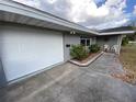 Single-story home with driveway leading to garage and beautifully landscaped front yard at 753 Avenue O Se, Winter Haven, FL 33880