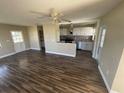 Spacious open-concept living area with laminate floors and a view into the kitchen at 100 High St, Winter Haven, FL 33880