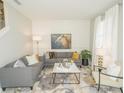 Inviting living room with stylish gray sofas, decorative pillows, and a patterned rug at 5888 Meditation Dr, Clermont, FL 34714