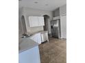 Kitchen view showcasing stainless steel appliances and tile flooring at 706 Lake Tarpon Way, Groveland, FL 34736