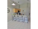 Eat-in kitchen featuring granite countertops and modern barstool seating at 1310 Seasons Blvd, Kissimmee, FL 34746