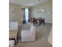 Spacious living room featuring neutral carpet and a dining area at 1310 Seasons Blvd, Kissimmee, FL 34746