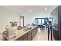 Open-concept kitchen with granite countertops and a view to the living area at 9362 Oglethorpe Dr, Groveland, FL 34736