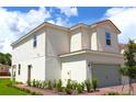 A charming two-story home featuring neutral siding and a well-manicured front yard under a bright blue sky at 628 Bay Leaf Dr, Poinciana, FL 34759