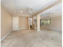 Spacious living area boasts neutral walls, carpet flooring, ceiling fans, and staircase at 819 22Nd Nw St, Winter Haven, FL 33881