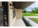 Inviting front porch with stylish lighting and well-maintained landscaping, adding curb appeal at 1897 West Pkwy, Deland, FL 32724