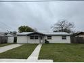 Charming single-story home featuring a well-maintained front yard and a concrete driveway at 427 Donald St, Lakeland, FL 33813