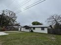 A charming single-story home with a lush green lawn and a concrete driveway at 427 Donald St, Lakeland, FL 33813