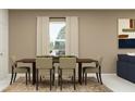 Dining room with a large window, modern art, stylish furniture and neutral tones at 942 Hour Glass Rd, Lakeland, FL 33801