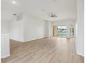 Spacious living room boasting light-colored wood floors and a ceiling fan at 2726 Herons Landing Dr, Kissimmee, FL 34741