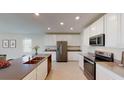Modern kitchen boasts stainless appliances, white cabinetry, and a large island at 4759 Golden Knight Blvd, Kissimmee, FL 34746