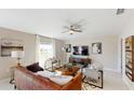 Comfortable living room boasting a leather sofa, modern decor, neutral walls, and natural light at 4765 Golden Knight Blvd, Kissimmee, FL 34746