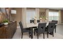 Cozy dining room with a neutral color palette and a window offering natural light at 4777 Golden Knight Blvd, Kissimmee, FL 34746