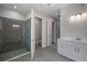 Modern bathroom featuring a glass-enclosed shower, double doors, and a sleek white vanity at 2050 Nw 79Th Loop, Ocala, FL 34475