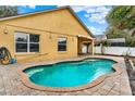 Relaxing backyard pool with a paver patio, perfect for outdoor entertaining and leisure at 390 Lisa Karen Cir, Apopka, FL 32712