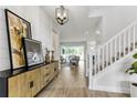 Inviting home entryway with wood-look tile floors, shiplap accent wall and staircase leading to upper level at 5789 Timber Meadow Way, St Cloud, FL 34771