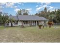 Single story home featuring a fenced yard with decorative trees at 15675 Sw 33Rd St, Ocala, FL 34481