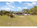 Generously sized yard featuring scattered palms and secure fencing, creating a private outdoor retreat at 15675 Sw 33Rd St, Ocala, FL 34481
