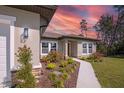 Inviting exterior featuring a beautifully landscaped yard and charming walkway leading to the front door at 524 Marion Oaks Blvd, Ocala, FL 34473