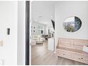 Bright entryway showcasing a wooden bench and decorative mirror, leading into a modern living space at 1324 Painted Bunting Ave, Oakland, FL 34787