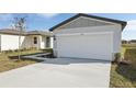 Single story home with a two-car garage and concrete driveway at 2530 Linda Knoll Ln, Bartow, FL 33830