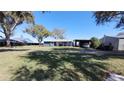 Property featuring a home with a carport and a spacious lawn at 3254 E Canal Ln, Fort Meade, FL 33841