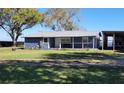 Charming home with a metal roof and a quaint porch at 3254 E Canal Ln, Fort Meade, FL 33841