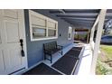 Inviting front porch with a bench and classic details at 3254 E Canal Ln, Fort Meade, FL 33841