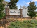 Stone entrance sign for Vista Del Lago community surrounded by lush landscaping at 1741 Hill Top Dr, Dundee, FL 33838