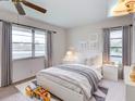 Cozy bedroom with natural light, neutral decor, and white furniture at 333 Lake Howard Dr Nw # 314D, Winter Haven, FL 33880