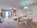 Bright living room with neutral colors, modern furnishings, and dining space at 333 Lake Howard Dr Nw # 314D, Winter Haven, FL 33880