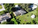 This aerial view shows a single-story home with large yard, storage shed and solar panels on the adjacent home's roof at 111 2Nd St # Jpv, Winter Haven, FL 33880