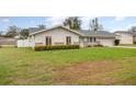 Charming single-story home featuring a well-manicured lawn and a light blue front door at 5105 Se 25Th St, Ocala, FL 34480